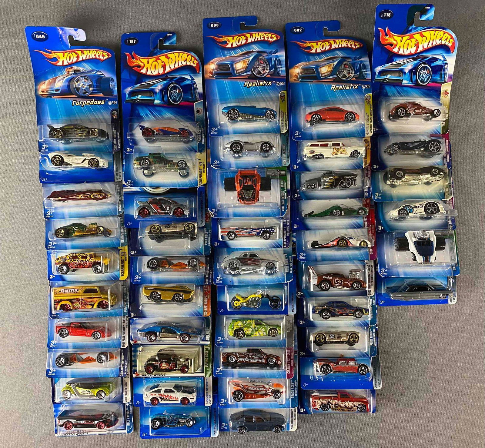 Group of 40+ Assorted Hot Wheels Die-Cast Vehicles: Includes Torpedoes, Realistix,Track aces and more, like new in original packaging, some has warped cardboard backing