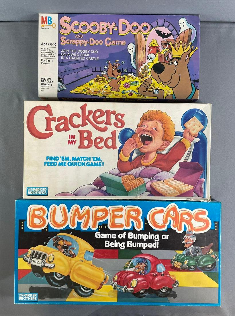 Group Of 3 Board Games: includes bumper cars, crackers in my bed, scooby door and scrappy doo game. largest measures 10 x 20 x 1 1/2 inches