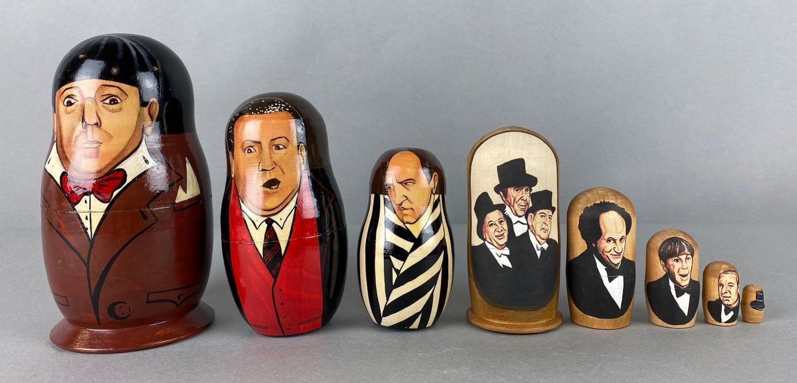 2 Sets of The Three Stooges Russian Nesting Dolls: 1 set Artist signed 1993, largest measures 6 1/4 X 3 1/4 inches