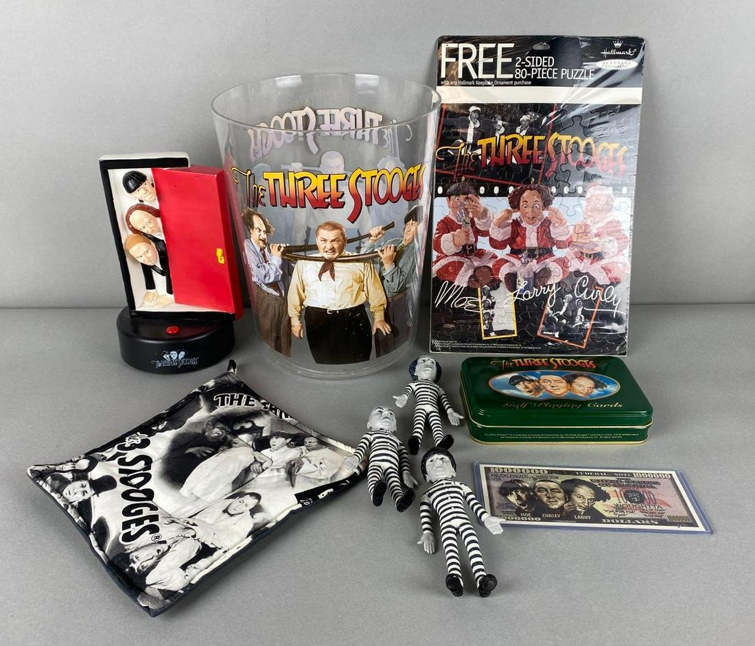 Group of 9 Assorted The Three Stooges Items: Includes plastic wastebasket, Hallmark puzzle, vinyl figures, and more, untested, Wastebasket measures 10 x 8 x 8in.