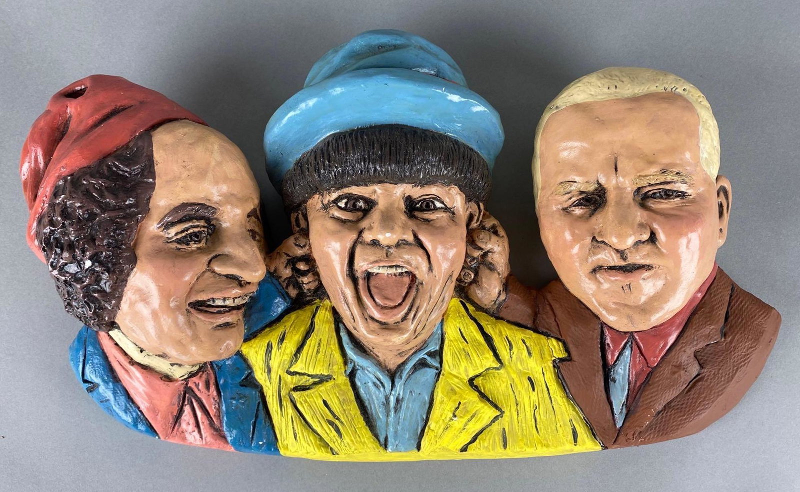 The Three Stooges Plaster Bust Wall Hanging Plaque: Curly broken off and repaired, still loose, Measures 10 x 17 1/2 x 3 1/2in.