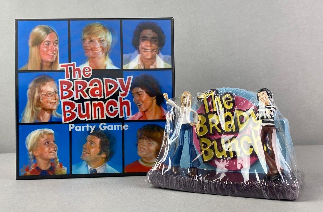Group of 2 The Brady Bunch Game and Candle: Figure is sealed but has chips. Game set appears complete. Packaging measures 9 x 9 x 3 inches