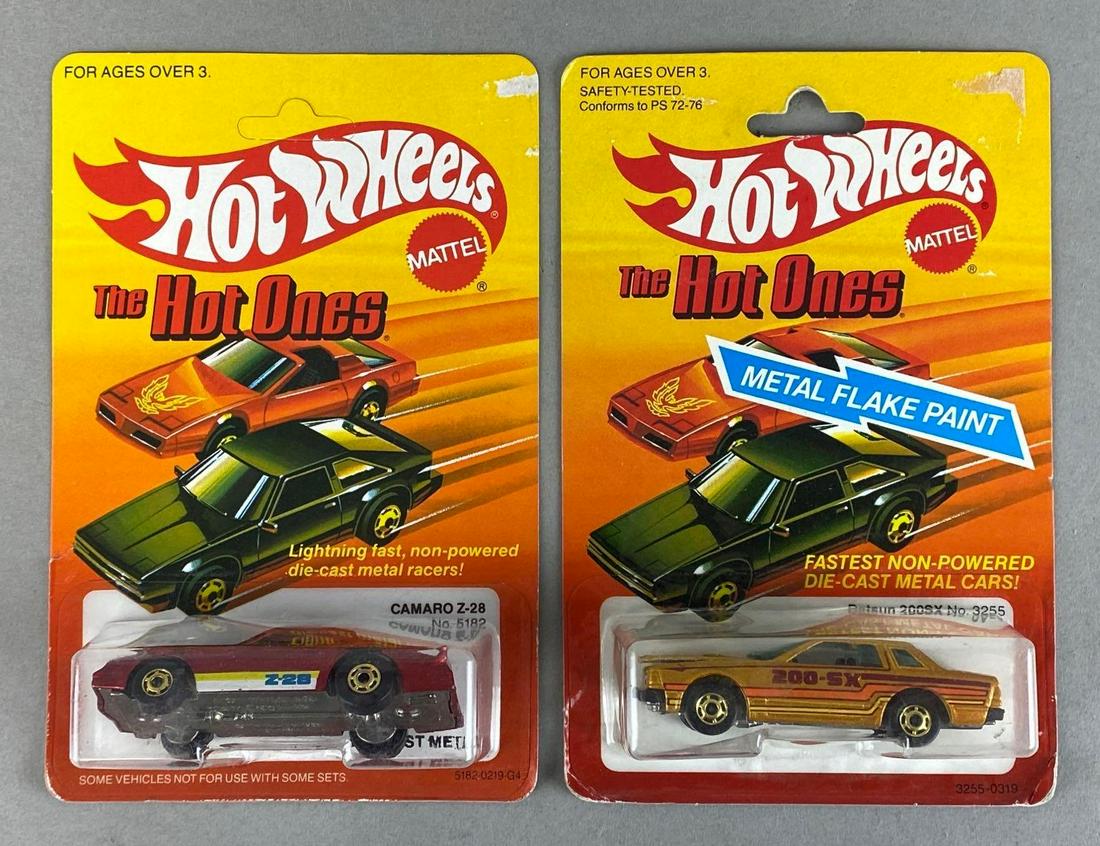 Group of 2 Hot Wheels The Hot Ones Die-Cast Vehicles: Mattel. Includes No. 5182 Camaro Z-28, and No. 3255 Datsun 200SX. In original packaging. Packaging measures 6 1/2 x 4 1/4 x 1 1/4in.