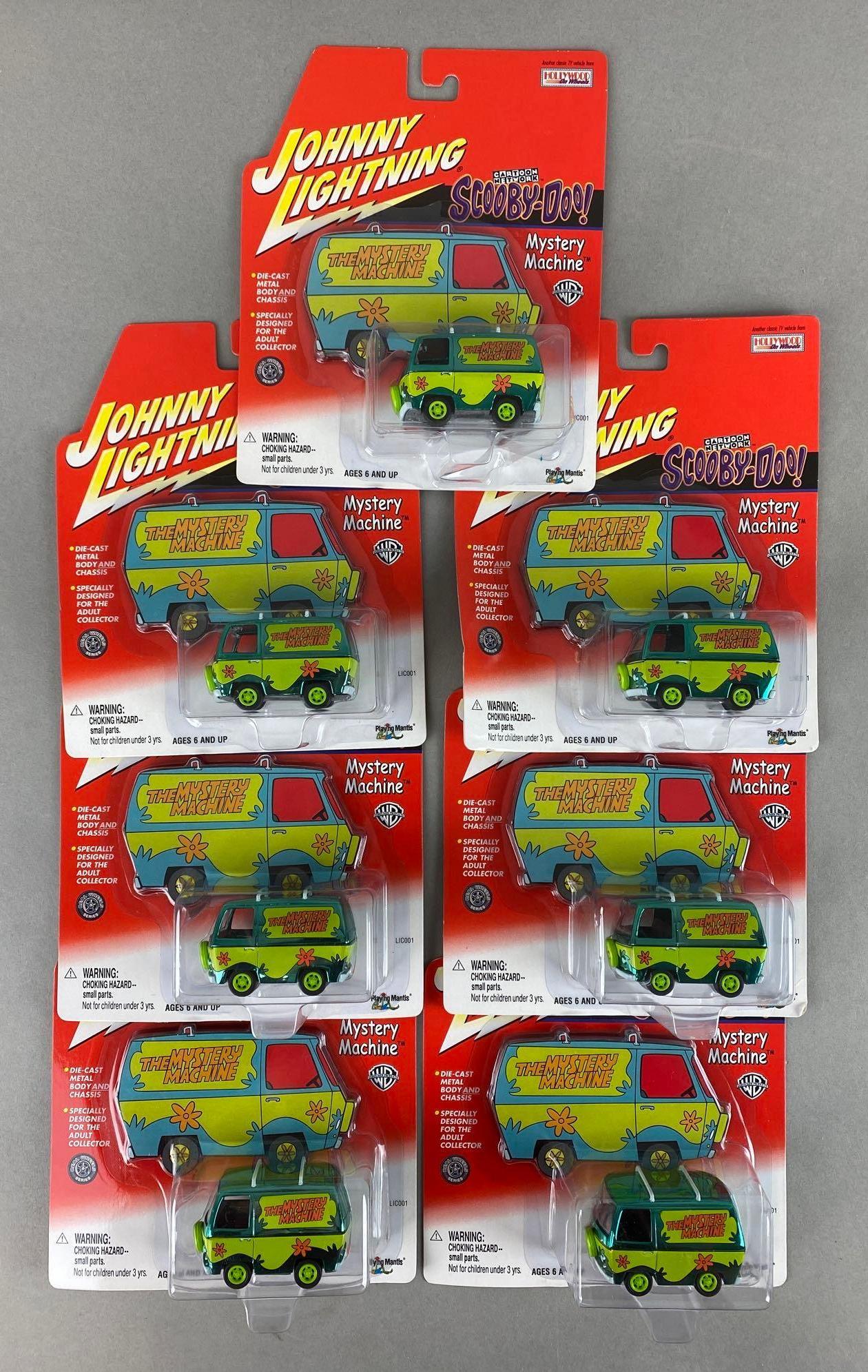 Group of 7 Johnny Lightning Scooby-Doo Mystery Machines: 2001. Playing Mantis. In original packaging. Packaging measures 7 1/2 x 6 1/4 x 1 3/4in.