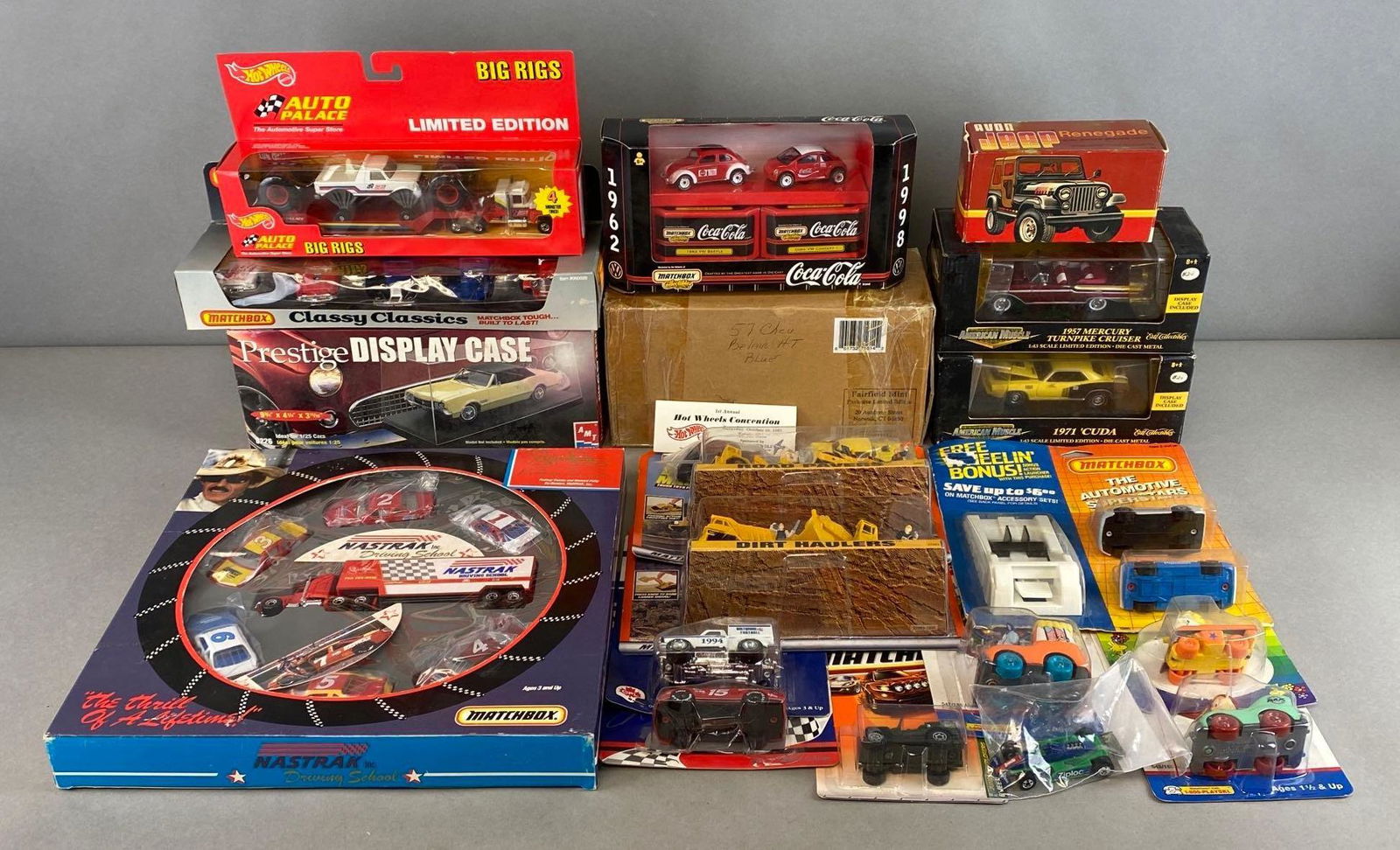Group of 20+ Assorted Die-Cast Vehicles and More: Includes Matchbox, Avon, Playskl, Hot Wheels, and more. Including display cases, gift sets, cartoon characters, and more. In original packaging. Largest packaging measures 12 x 12 x 1 3/4in.