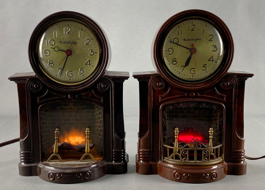 Group of 2 Mastercrafter Model No. 272 Fireplace Mantle Clocks: Electric, One missing front grate, In working condition but one doe not rotate, Both measure 10 1/2 x 7 1/2 x 4in.