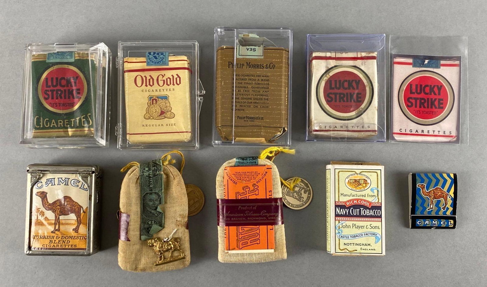 Group of 10 Vintage Cigarette Packs and More: Includes WWII Lucky Strike Green, Phillip Morris Pack, Old Gold, and more, Largest measures 4 x 2 3/4in.