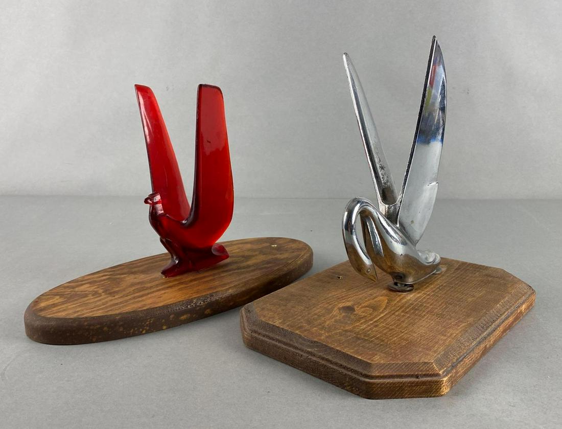 Group of 2 Assorted Hood Ornaments: Includes Metal 1950 Packard, and Acrylic 1949-51 Ford Crestline, Both mounted on wood, Largest measures 9 x 6 3/4 x 10in.