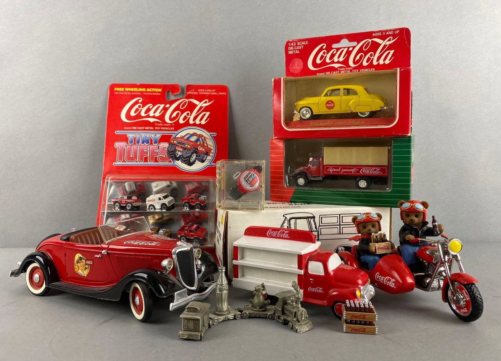 Group of 9 Assorted Coca-Cola Advertising Merchandise: Includes die-cast, On the Go with Coca-Cola (COA), and more. Largest measures 3 1/2 x 9 1/2 x 4 inches