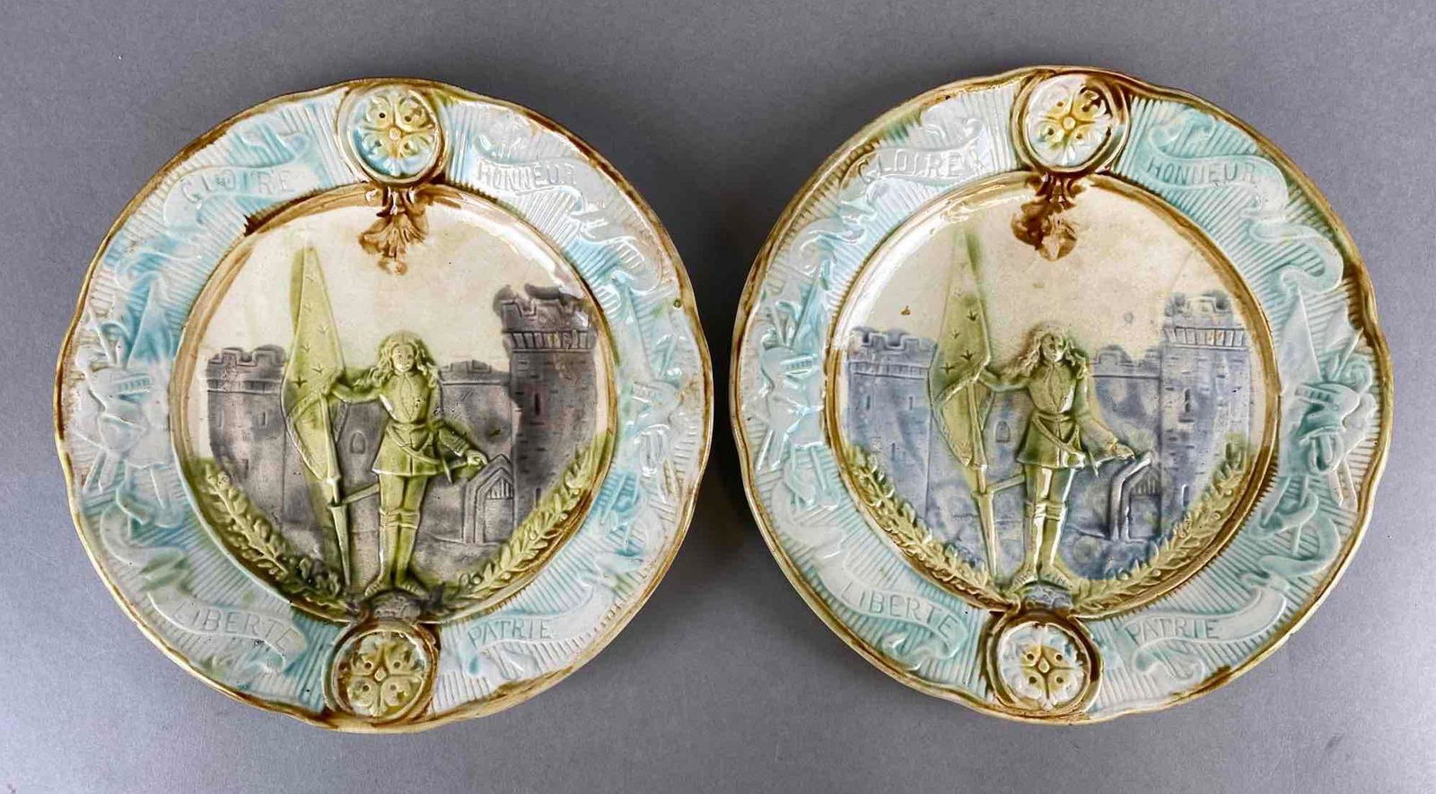 Group of 2 French Joan of Arc Majolica Porcelain Plates: Crazing, some chipping around edges, measures 8 1/2 inch diameter
