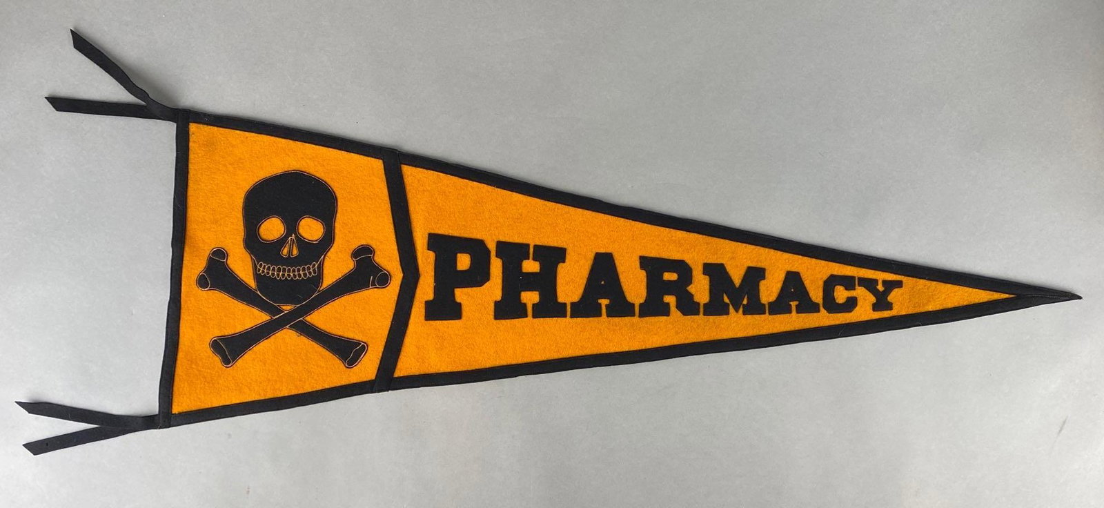 Pharmacy Skull and Crossbones Felt Advertising Pennant: Chicago Pennant Co. Inc., Measures 14 1/2 x 40in without tassels.