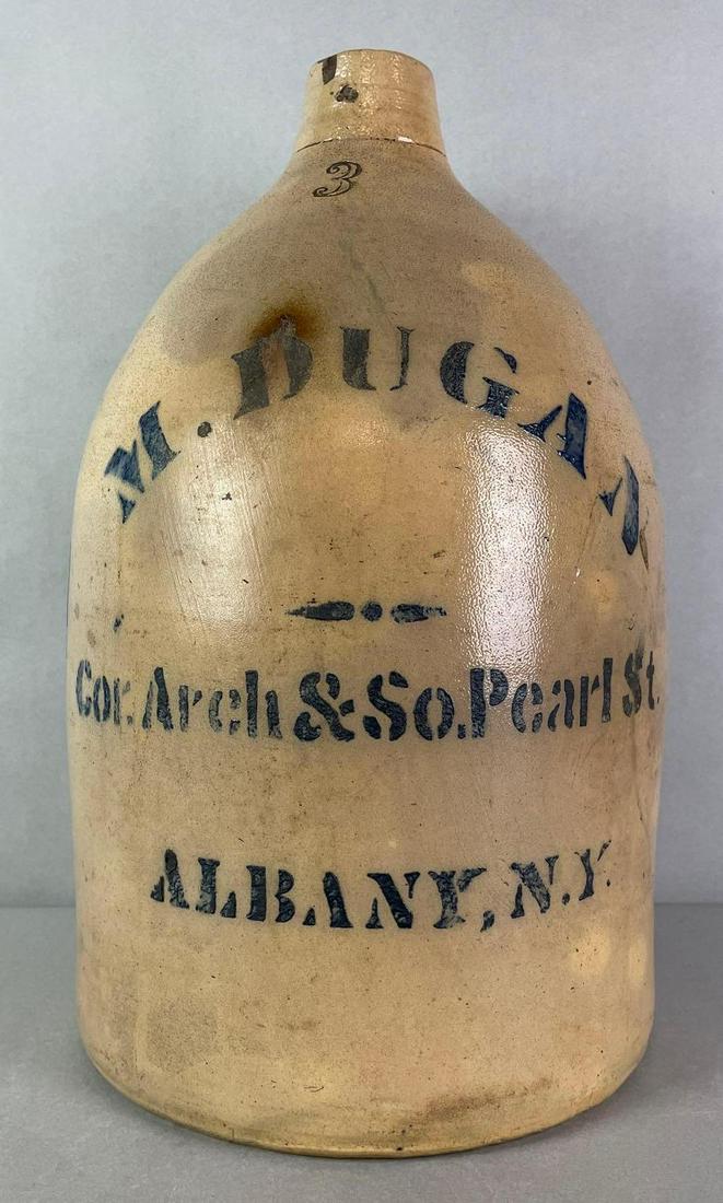 M. Dugan Cor. Arch and So. Pearl St Albany NY 3 Gallon Salt Glaze Advertising Jug: small chips near the mouth. measures 17 x 10 1/4 inches
