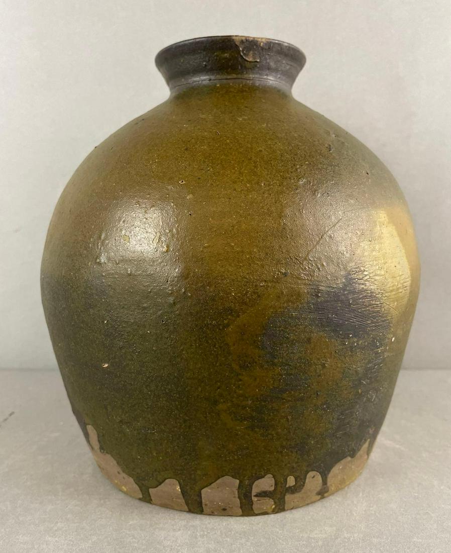 1 Gallon Salt Glaze Ovoid Crock: An unusual green-orange glaze that is not dipped completely. Underfired canner with chip at top rim. measures 9 x 8 inches