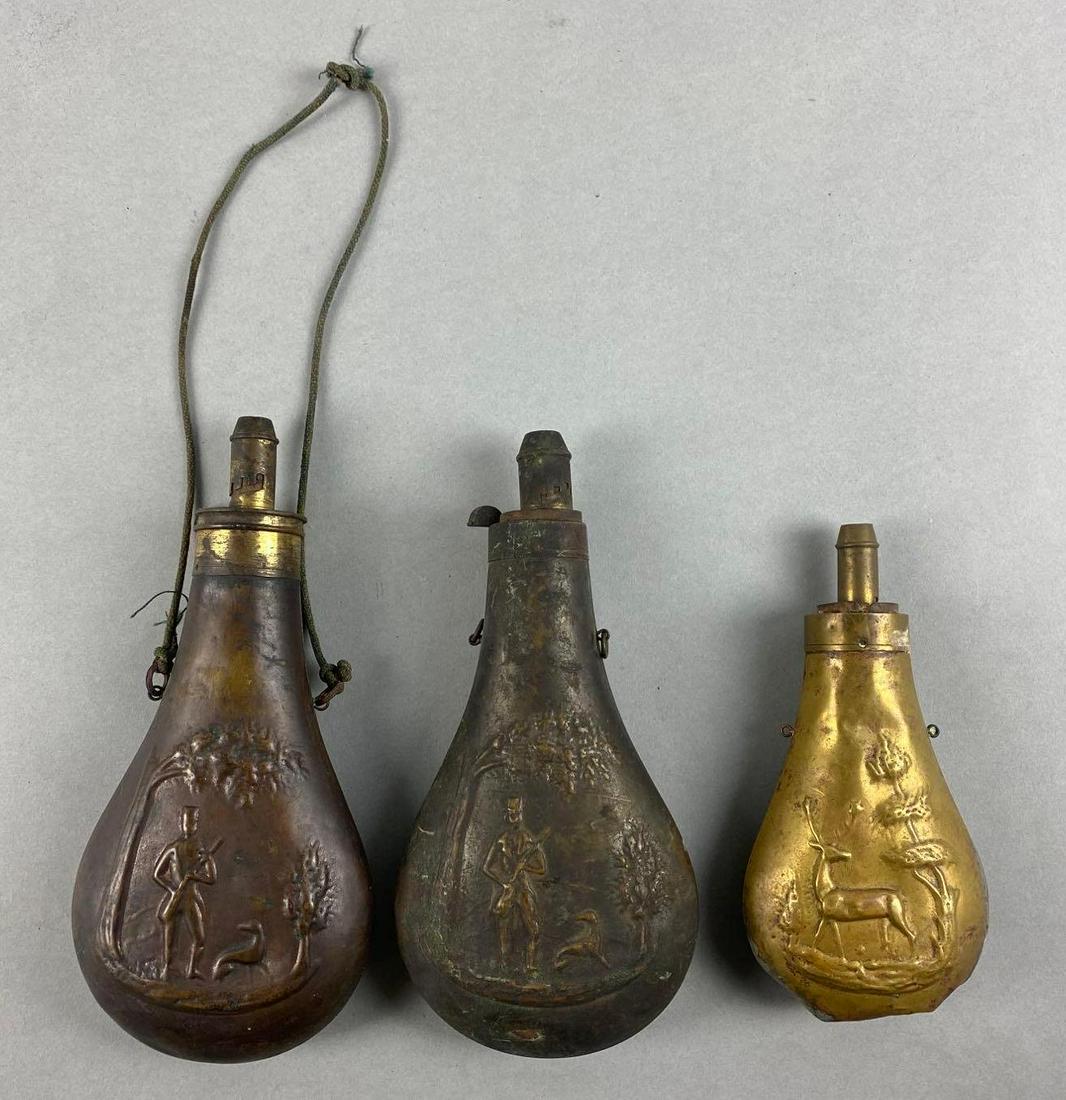 Group of 3 Antique Brass and Copper Powder Flasks: Largest measures 9 x 4 inches.