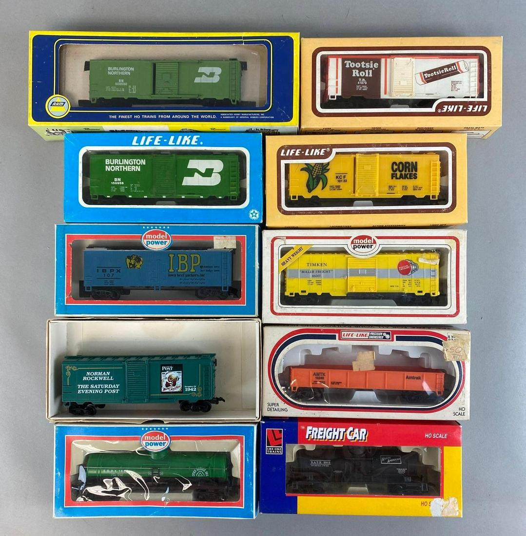 Group of 10 HO Scale Train Cars: Not original boxes, Includes KC F Corn Flakes Boxcar, Norman Rockwell The Saturday Evening Post Boxcar, City Service Oils Tanker, and more, Longest train car measures 6in long.
