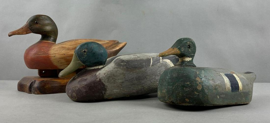 Group of 3 Wood Duck Decoys: Largest measures 9 1/2 x 14 x 4 inches.