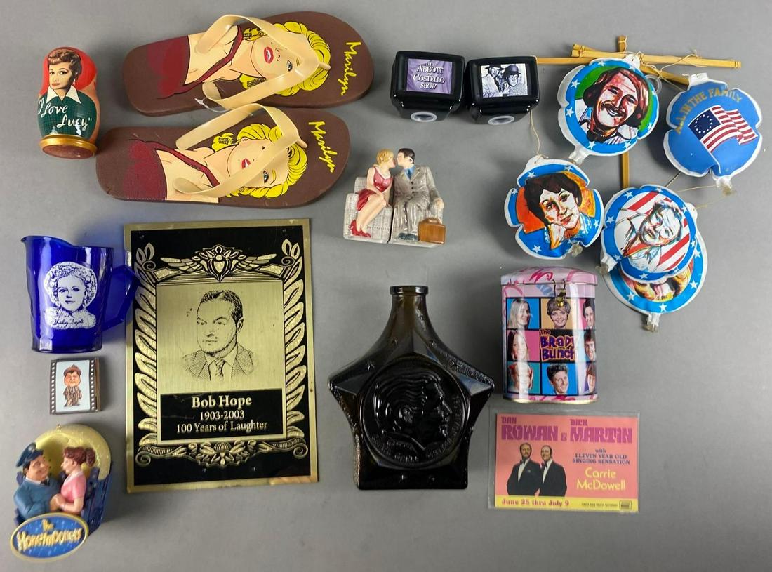 Group of 12 Assorted Comedy Items: Includes Clark Gabe Bottle, The Abbott and Costello Salt and Pepper Shakers, I Love Lucy Russian Nesting Dolls, and more. Bottle measures 7 1/2 x 6 x 2 inches