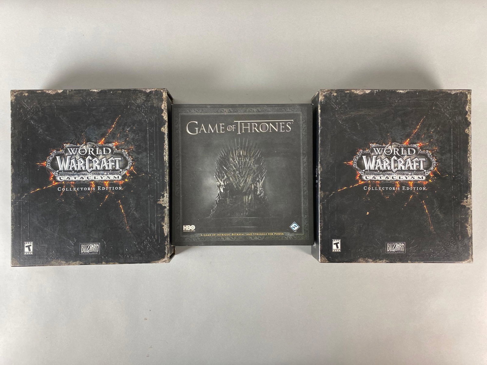 Group of 3 World of Warcraft and GOT Games and More: Includes (2) World of Warcraft WOW Cataclysm Collectors Edition Sets, and (1) Game of Thrones Card Game, Unknown game set completions, Largest box measures 12 x 10 3/4 x 2 3/4in.