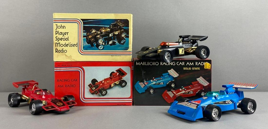 Group of 3 Assorted Racing Car Radios: Includes John Player Special Modelised Radio, Marlboro Solid State Racing Car, and Racing Car AM Radio. Original boxes, untested. Largest measures 3 x 9 1/2 x 5 inches