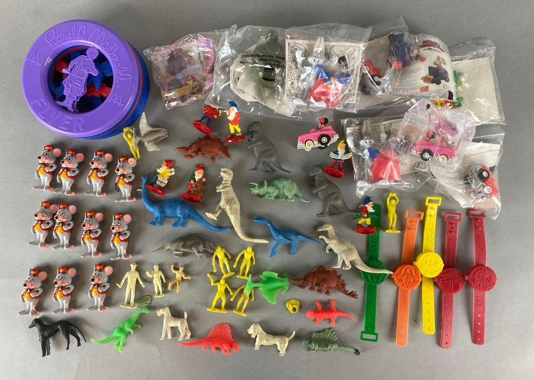 Group of Assorted Kids Meal Toys and More: Includes McDonalds, Chuck E. Cheese, Dinosaurs, and more, Largest measures 6in across.