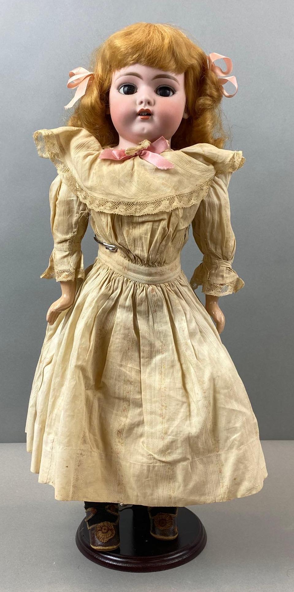 Antique Bisque Doll: Back of head is unmarked. Composite hands. Sleepy heads, 19 1/2 inches tall. Dress is ripped.
