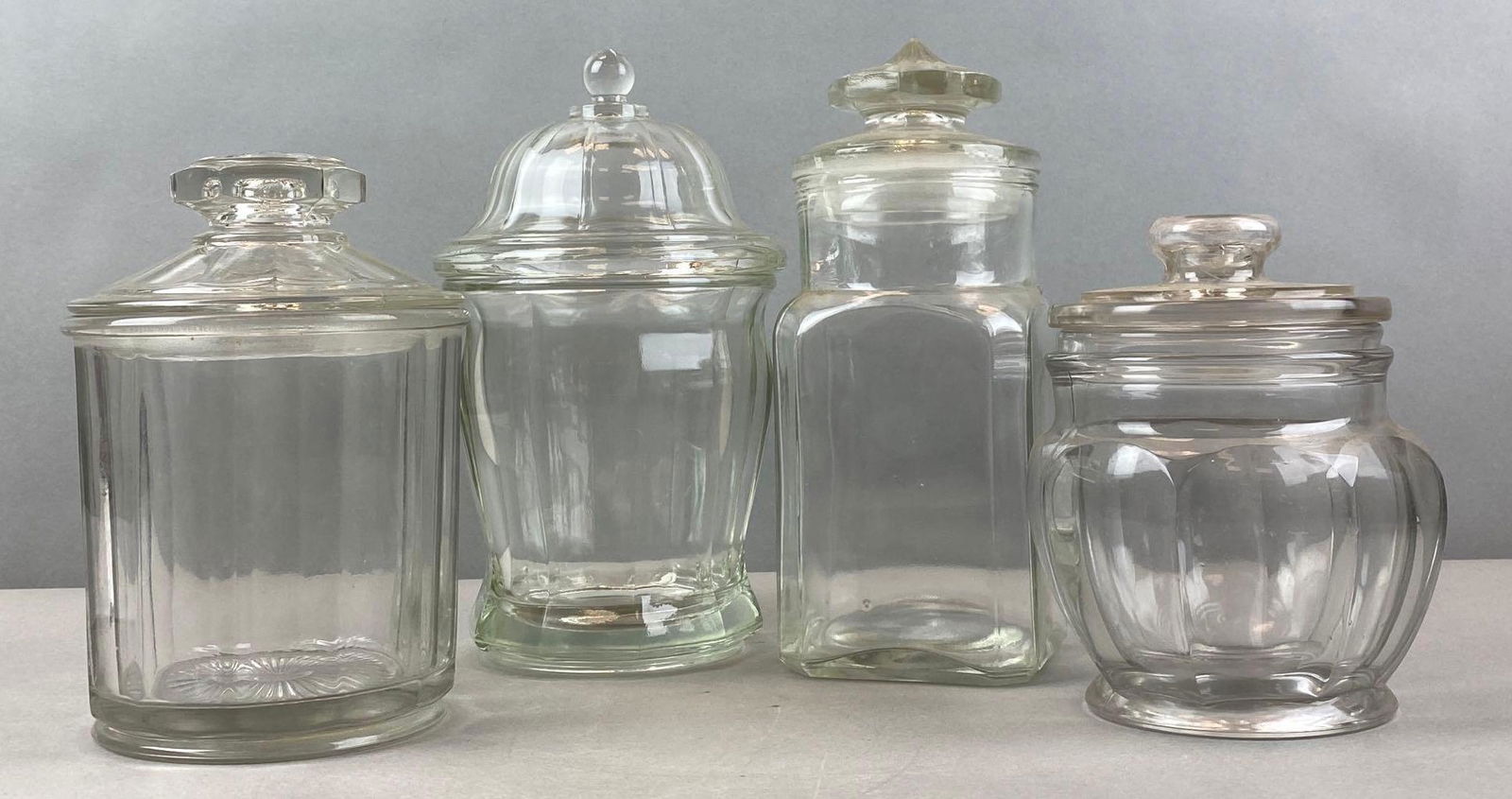Group of 4 Glass Candy Jars: Largest measures 10 1/2 x 5 1/2 inches