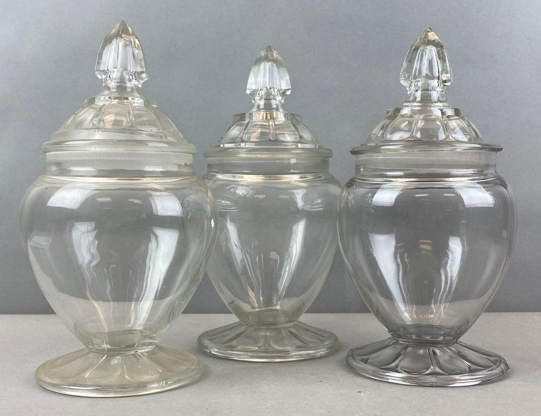 Group of 3 Glass Apothecary Jars: Unmarked. Largest measures 11 x 5 1/2 inches