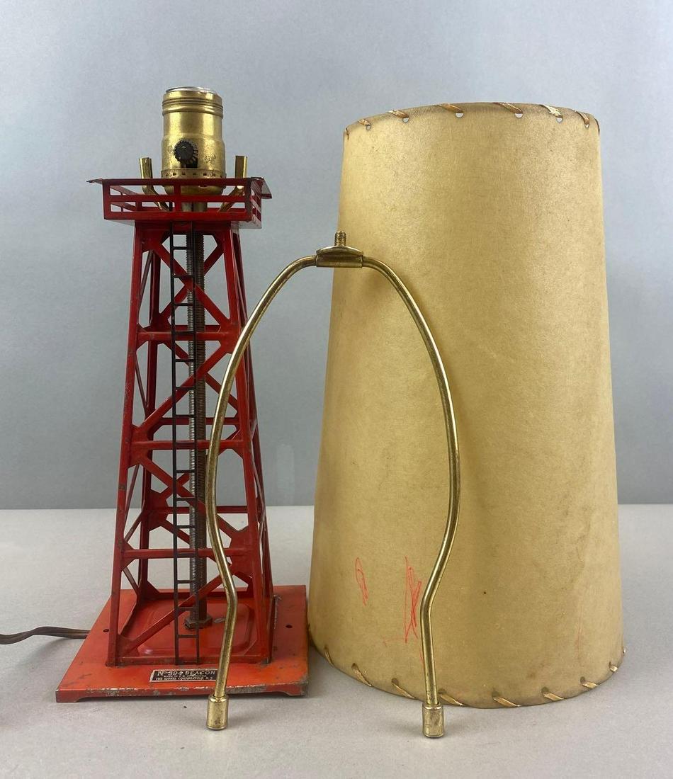Lionel No. 394 Beacon Lamp: converted and electrified, non working condition. Harp does not fit into saddle points, shade has markings. Lamp itself measures 12 1/2 x 5 x 5 inches