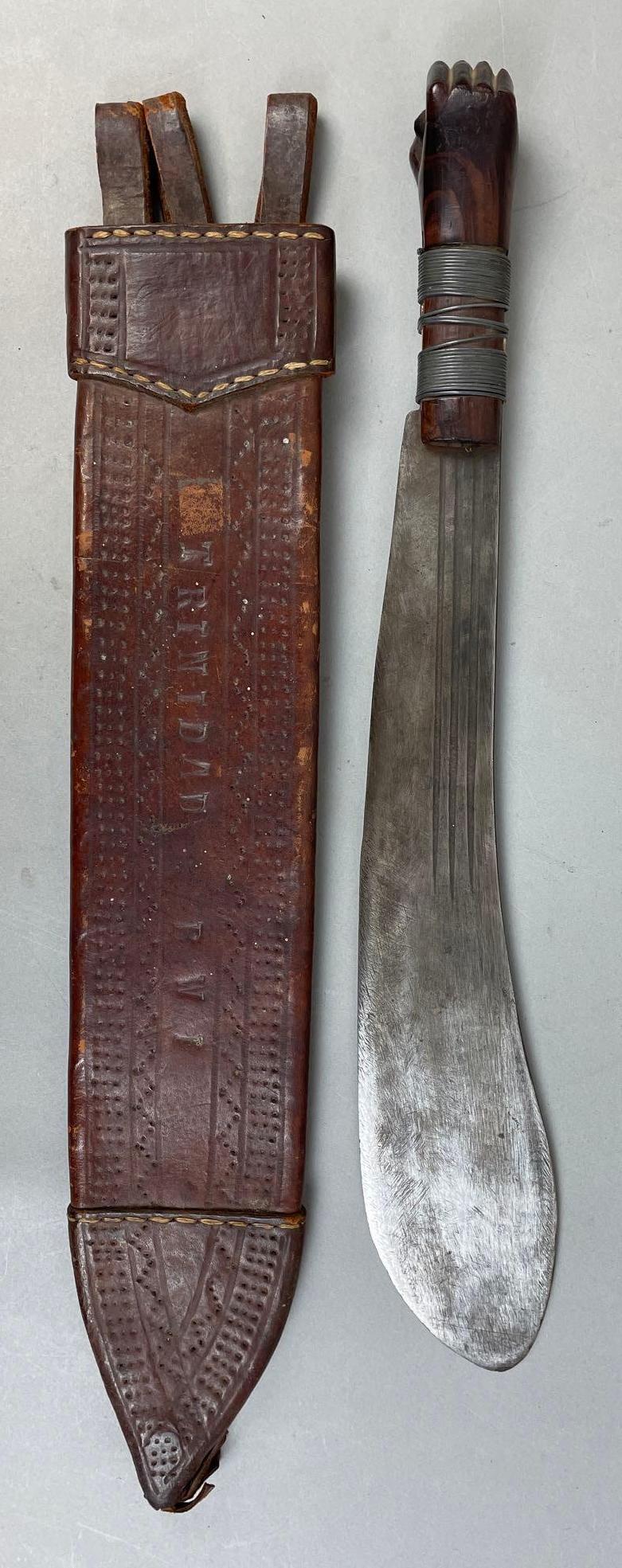 WW2 Identified British Machete with Leather Sheath: Identified C.W. Knauel on sheaf. Wood fist handle bound with metal wire. Sheaf reads Trinidad BWI. Sheathed measures 25 x 4 inches