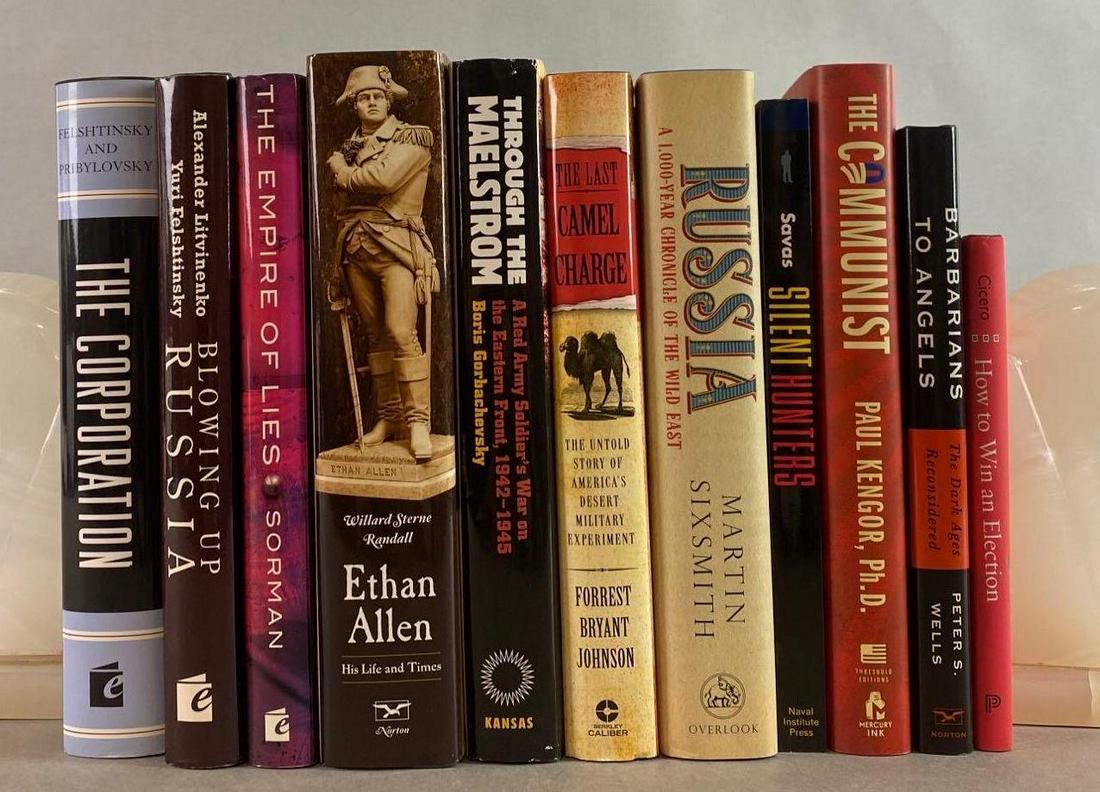 Group of 11 Assorted Military Books: Bookends not included. Includes The Communist, The Last Camel Charge, The Corporation, and more.
