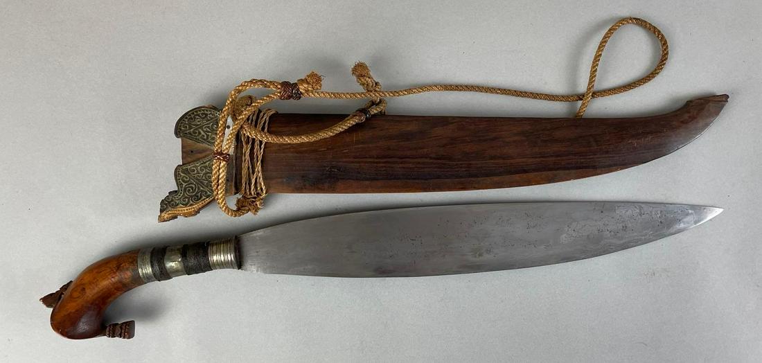 Philippine Barong Knife with Wood Scabbard: Scabbard separating down spine. Pieces missing at top of scabbard. Knife measures 21 1/2 inches overall with a 15 1/2 inch blade