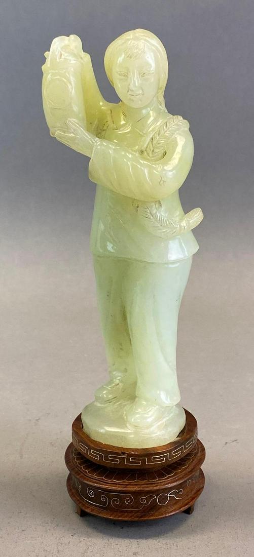 Carved Pale Green Jade Asian Woman with Lantern Figurine: With wood carved base, Measures 7 3/4 x 2 1/2 x 2 1/2in with base, Measures 6 1/2 x 2 1/4 x 1 3/4in without base.