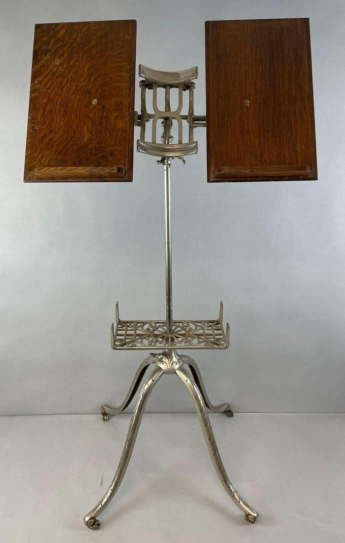 Antique Sheet Music/Book Stand: Oak and metal, fully adjustable, with casters. Measures 44 1/4 x 21 1/4 x 16 3/4 inches