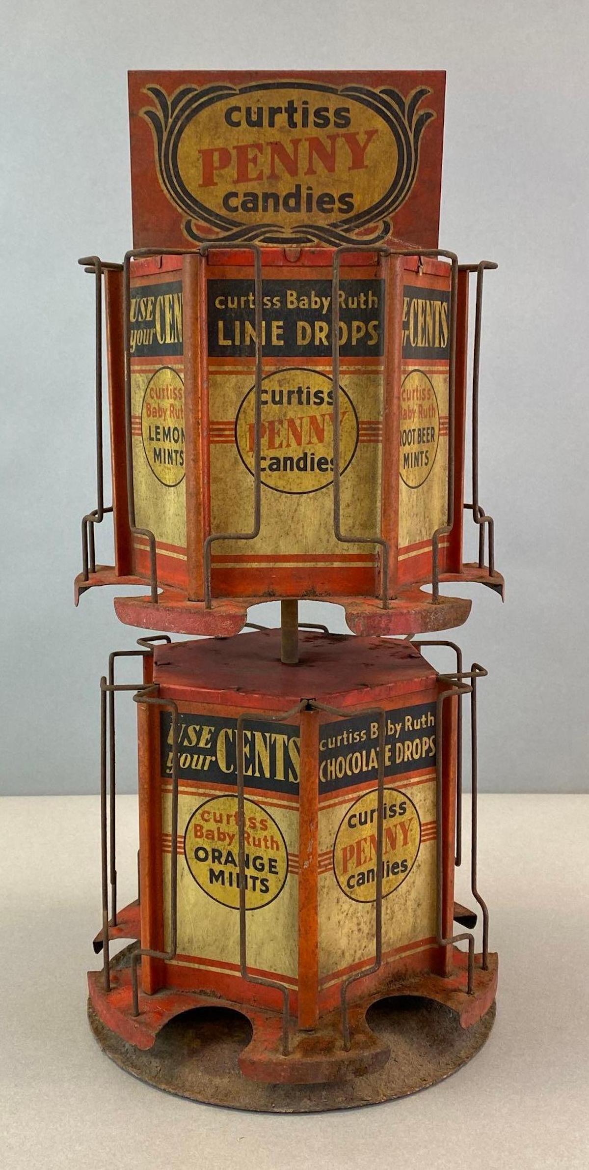 Curtiss Penny Candies Rotating Tin Advertising Countertop Display: Bottom rusted, Features wintergreen mints, orange Mingâ€™s, root beer mints, and more, Measures 16 1/2 x 7 x 7in.