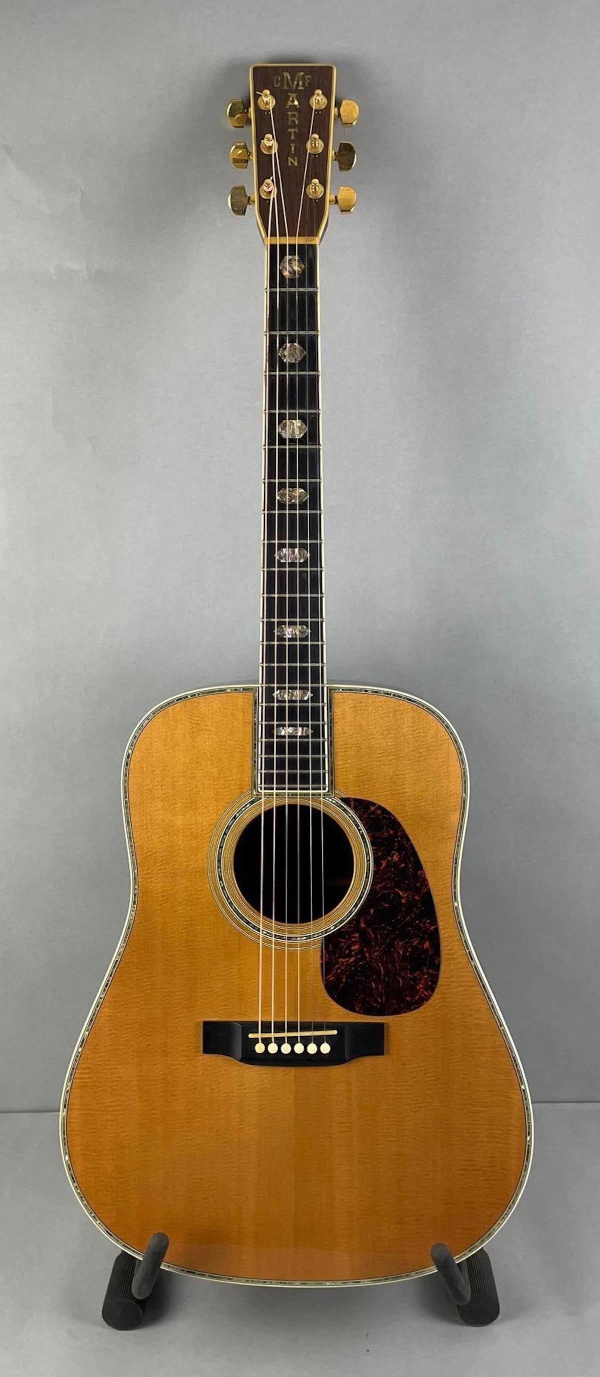 Martin D45 Acoustic Guitar with Case: Serial number 794523. Hard shell case. Mother of pearl inlays. Includes case key, planet waves humidipack, and temp and humidity reader. Guitar measures 40 1/2 x 15 5/8 x 4 3/4 inches. Neck measures 1