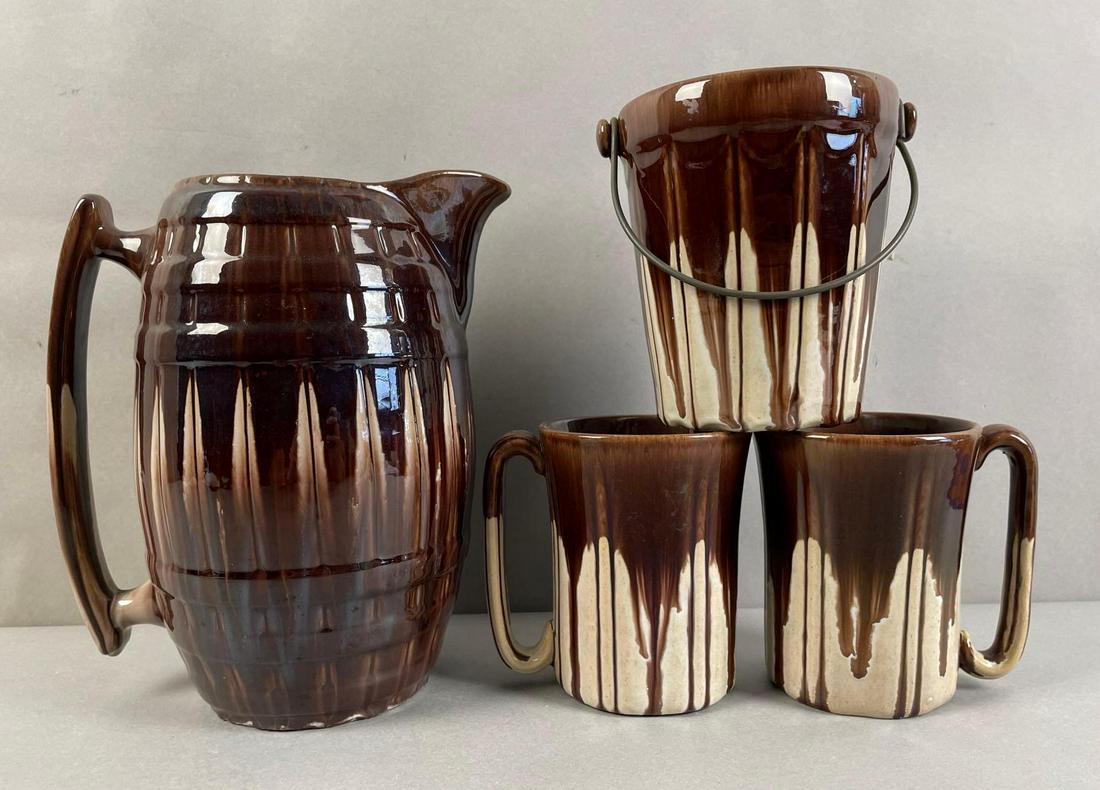 Group of 4 Stoneware Beer Set: Includes pitcher, 2 mugs, and ice pail with handle. Pitcher measures 9 1/2 x 6 x 8 1/2 inches