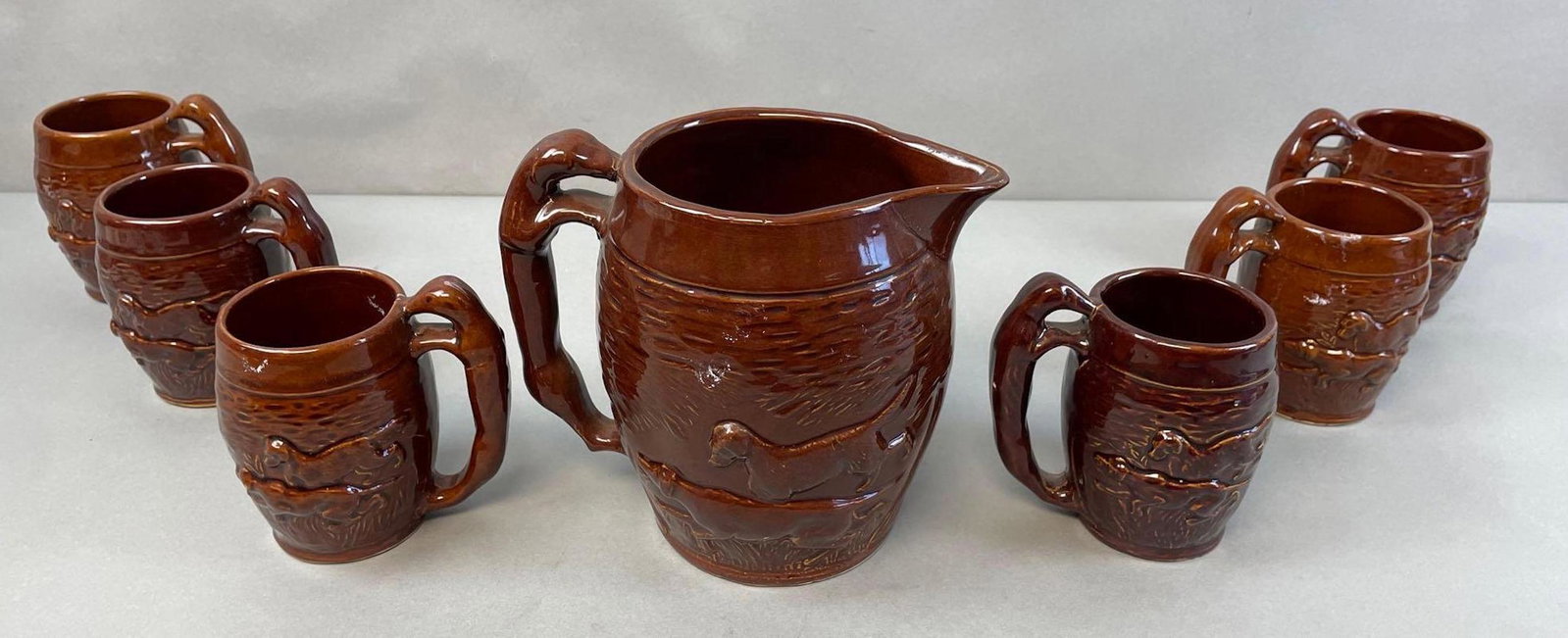 Group of 7 Hunting Dogs Pitcher and Beer Mugs: Many have pink house paint on them, but picks off easily. Pitcher measures 7 1/2 x 6 inches