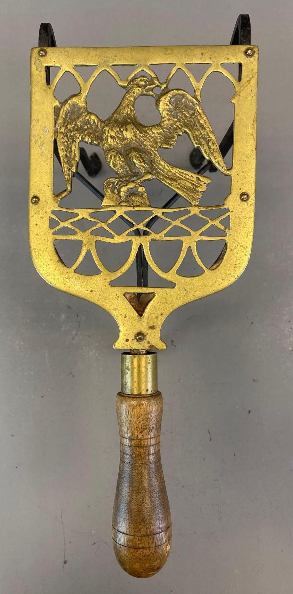 Brass and Iron Fireside Eagle Trivet: With wood handle, Measures 8 x 5 1/2 x 13 1/2in.