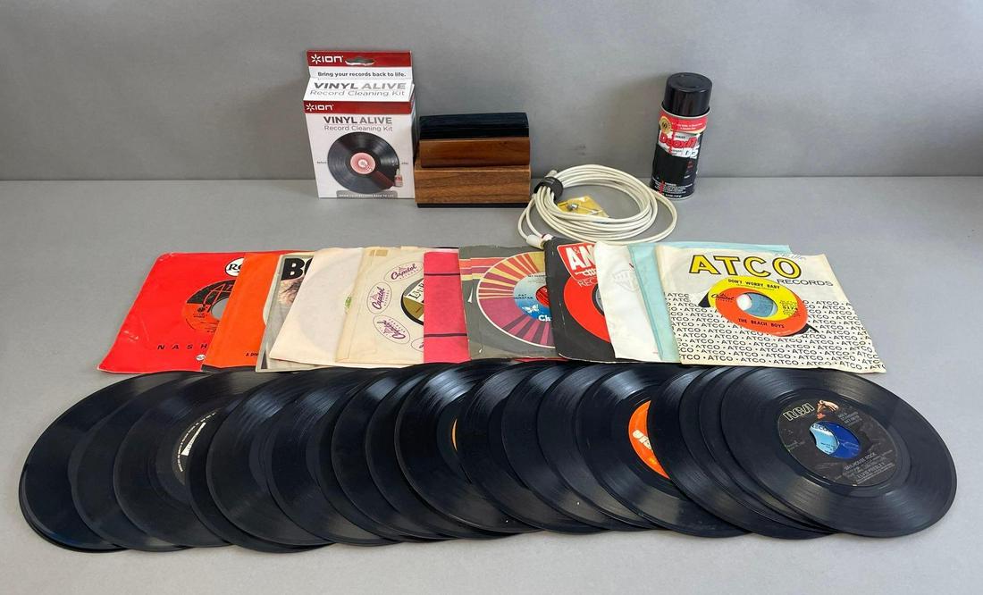 Group of 45 RPM Records and Vinyl Cleaning Items: Includes 30 vinyl 45s, with Elvis Presley, beach boys, Bob Dylan, and more. Cleaning brush measures 5 x 2 1/4 x 2 inches