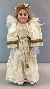 Edna Hibel AE2 Porcelain Angel Doll: With original box, Hands and feet bubble wrapped, Doll Stand included, Box measures 25 x 11 1/4 x 8 1/2in., Doll measures 22 1/2in tall.