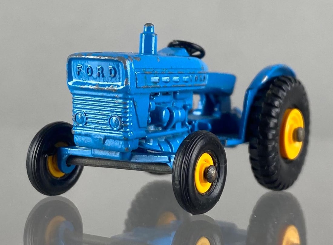 Matchbox No. 39 Ford Tractor: Lesney, Made in England. Color: Blue, Black Plastic Wheels with yellow rims, some wheels are loose, Die-Cast.