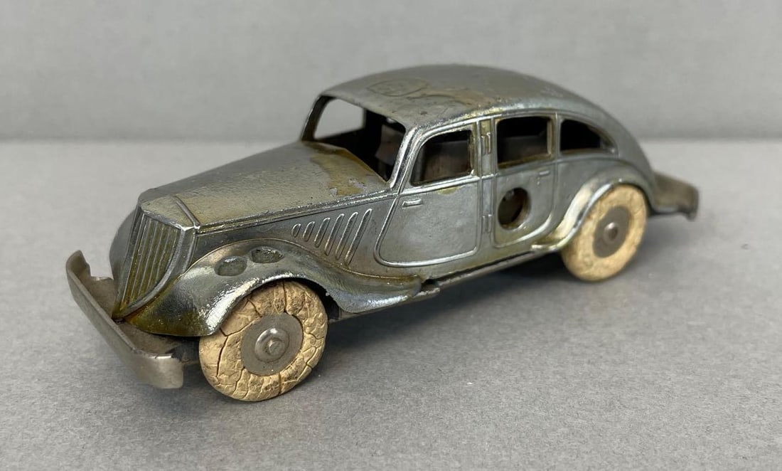 Vintage Solido Wind-Up Sedan Diecast Metal Car: Untested, bottom frame cracked, discoloration on top, with some pitting. Measures 3 5/8 inches