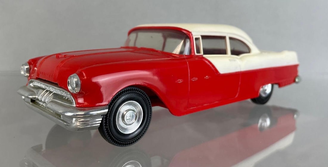 Jo-Han 1955 Pontiac Star Chief 2 Door Hardtop Dealership Promo Car: two tone red and white, no interior, non-friction. Measures 8 1/2 x 3 x 2 1/4 inches