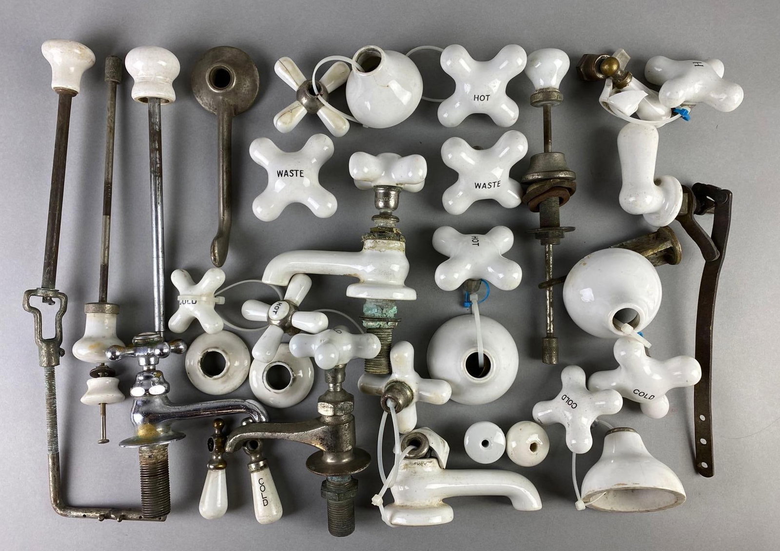 Group of 20+ Porcelain Knobs and Spouts: Parts cracked, largest measures 15 x 4 x 1 1/2 inches