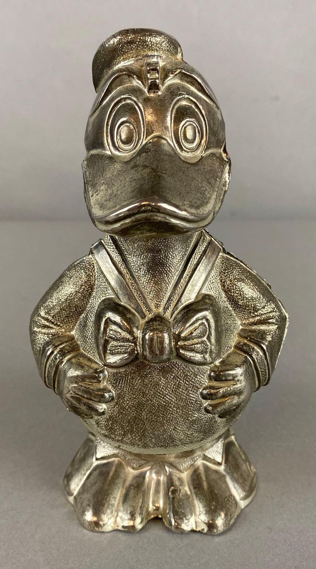 Walt Disney Donald Duck Silver Plated Coin Bank: Cavalier, Made in England, Measures 6 1/4 x 3 1/4 x 3 3/4 inches.