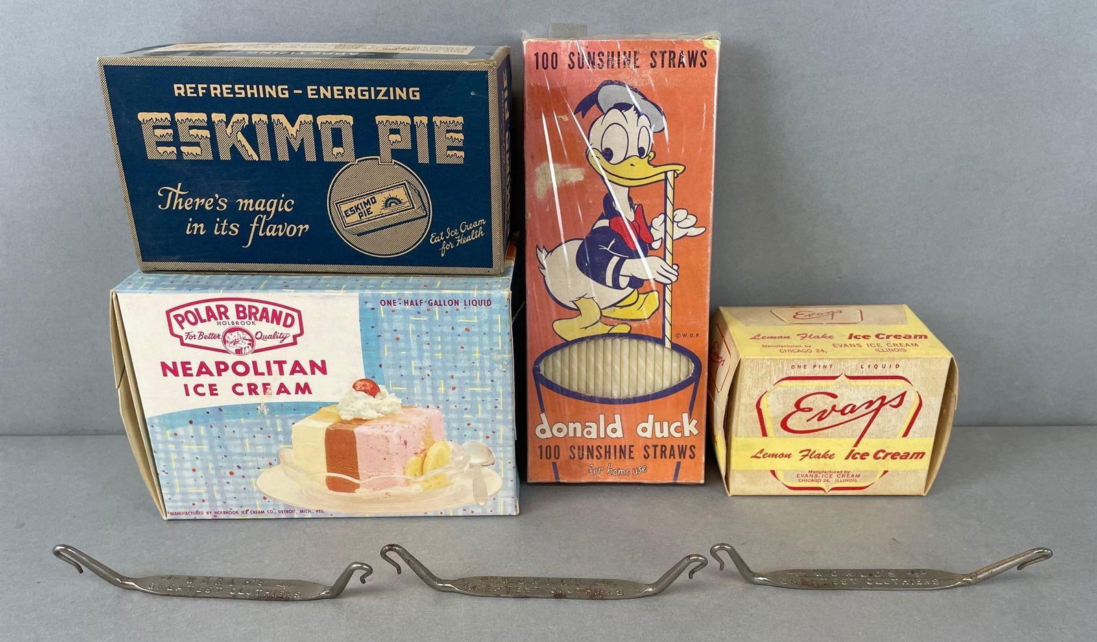 Group of Vintage Ice Cream Advertising Boxes and More: Includes sealed Donald Duck 100 sunshine straws, evans lemon flake ice cream box, H C Schrink and son Eskimo pie box, and more. Largest measures 7 x 5 x 3 1/2 inches