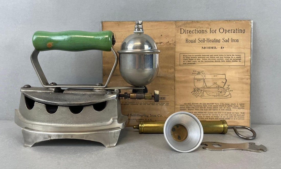 Antique Royal Model D Self Heating Sad Iron: Includes operating instructions, filter funnel, brass air pump, wrench, and stand. Measures 8 x 9 1/2 x 4 1/4 inches with stand
