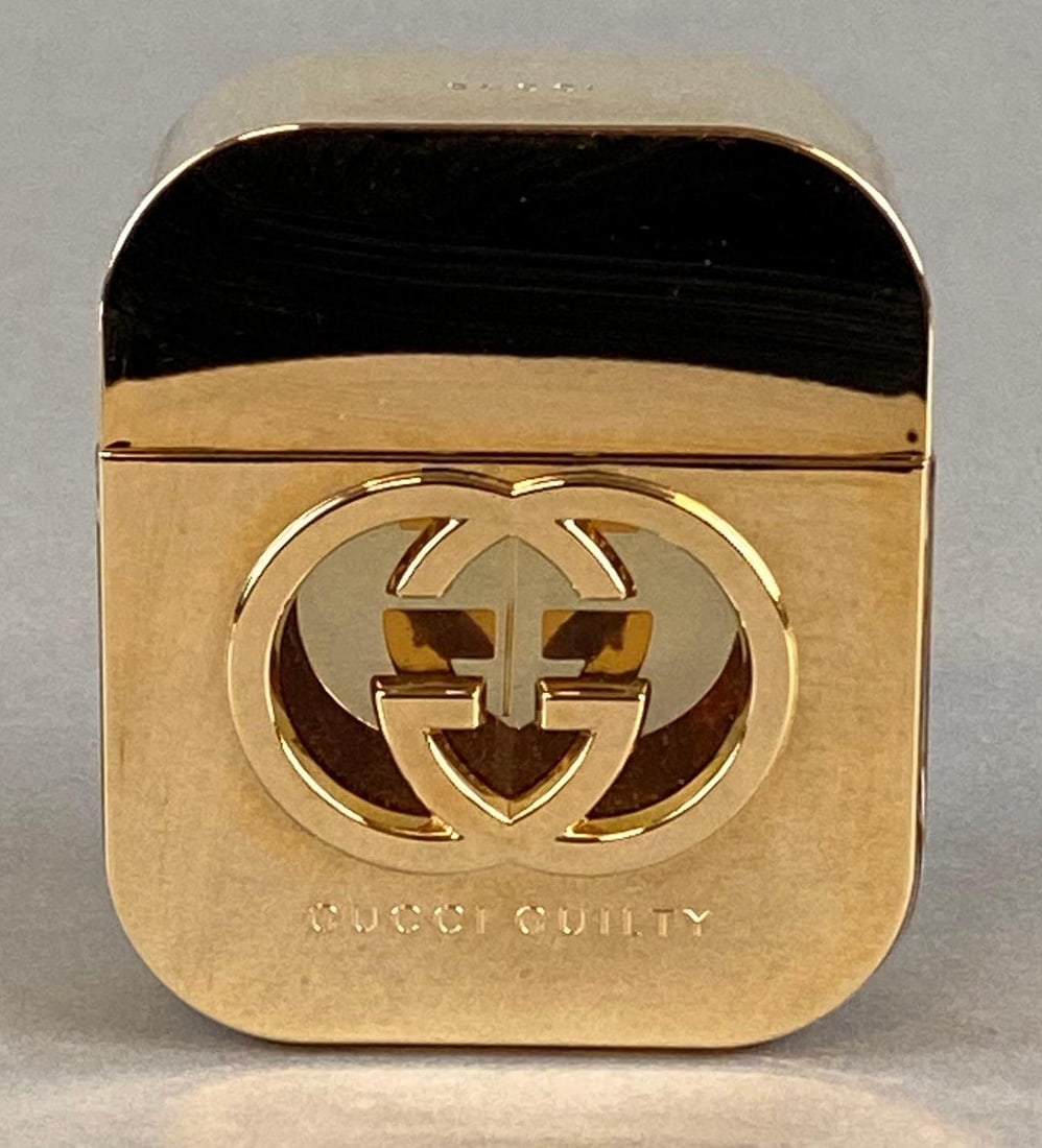 Gucci Guilty Perfume Bottle: Nearly full bottle, Measures 3 1/4 x 2 3/4 x 1 1/4 inches.