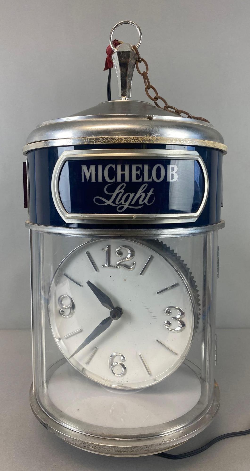 Michelob Light Advertising Hanging Rotating Motion Beer Clock: Rotation, clock and light working. Measures 21 x 11 x 11 inches. Some wear. See photos for surface condition.