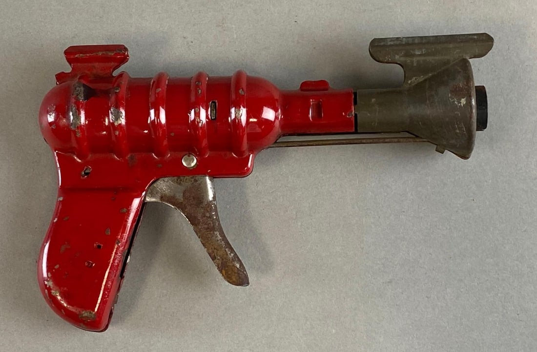 Vintage 1930s Red Space Metal Toy Pop Gun: Pull trigger and works. Surface wear. Measures 4 1/2 x 7 x 2 inches.